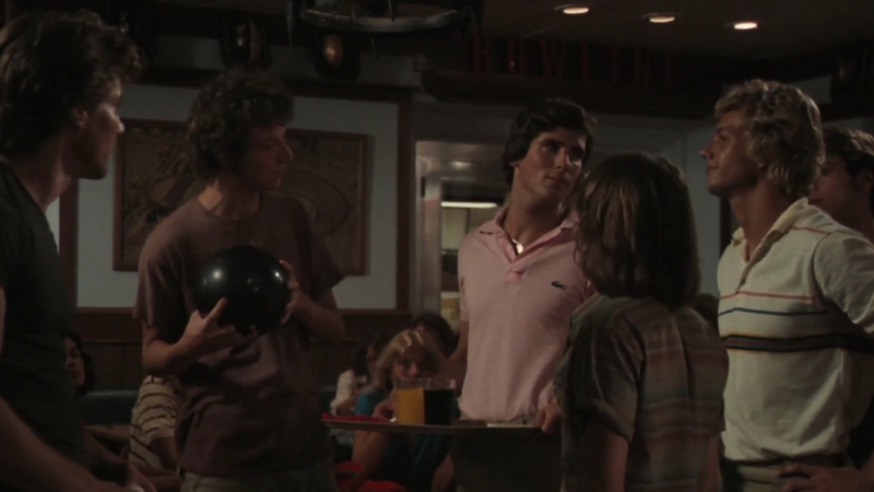 A group of young men face off in a tense moment inside a crowded bowling alley scene from Breaking Away (1979), filmed in Bloomington, Indiana