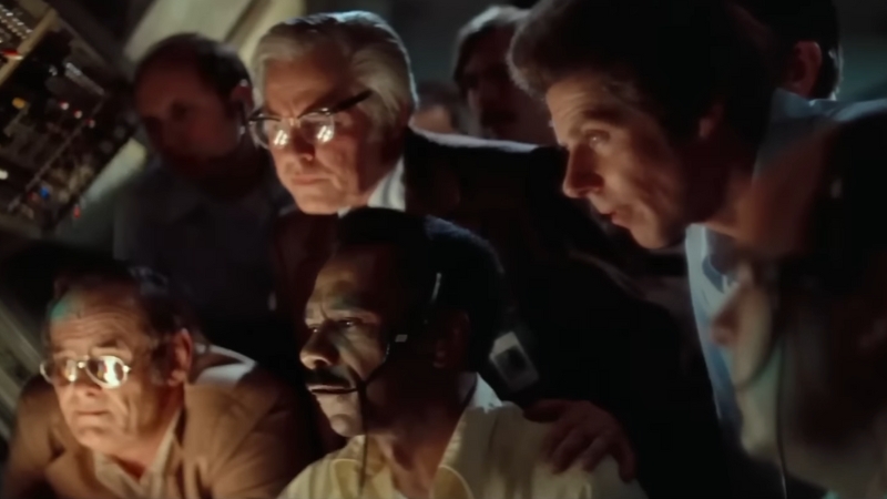 A group of men intensely monitor signals in a control room during a key UFO contact scene from Close Encounters of the Third Kind