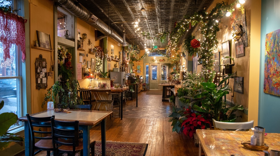 A warmly lit café in Brown County, Indiana, decorated with string lights, plants, and eclectic artwork