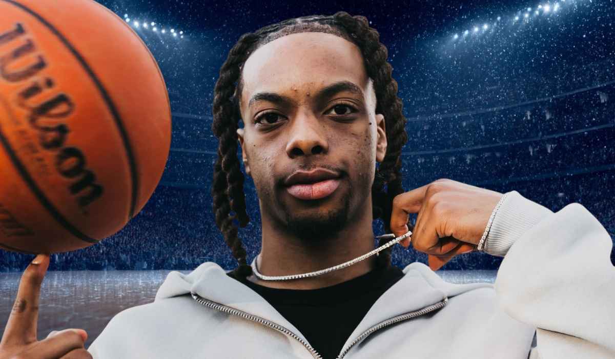 Basketball player holding a chain and a basketball in a stadium under bright lights