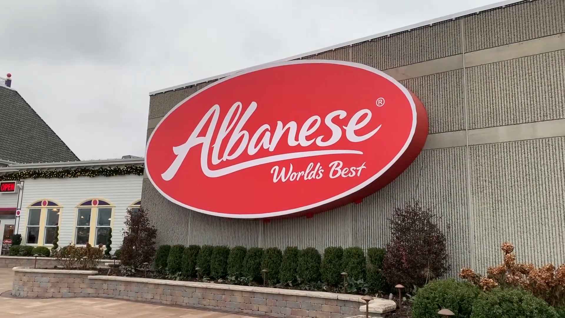 Large red Albanese Candy Factory sign reading “World’s Best” on the exterior wall of the factory building