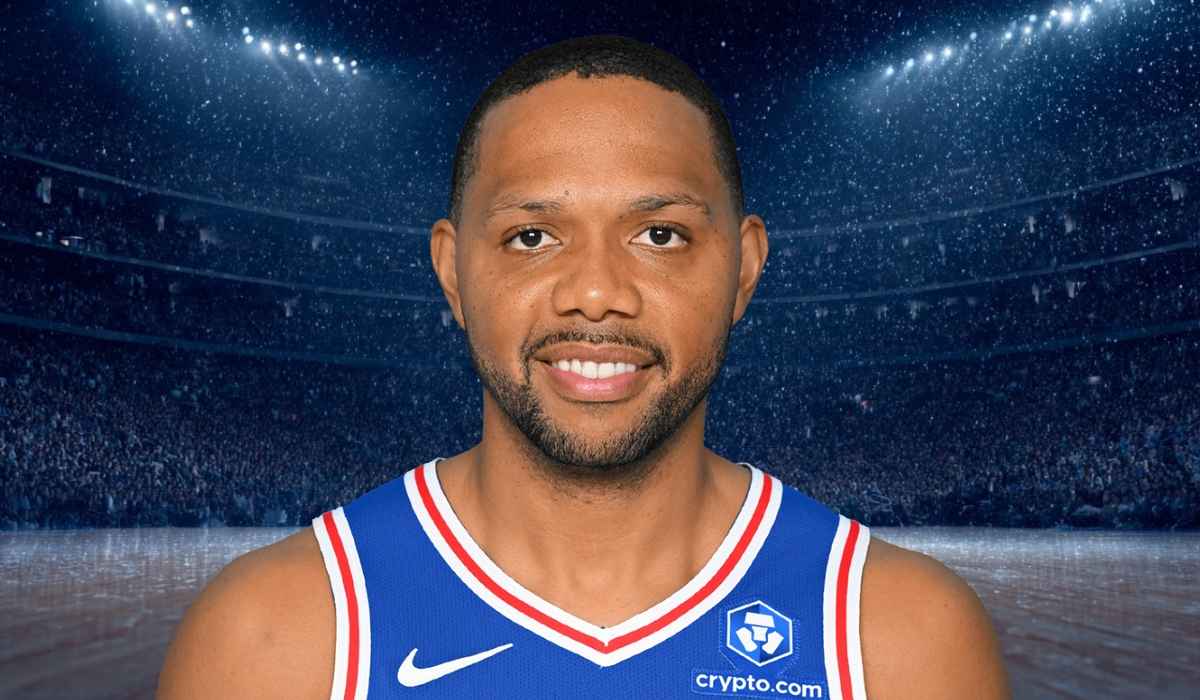 Basketball player in a blue jersey standing in an indoor arena