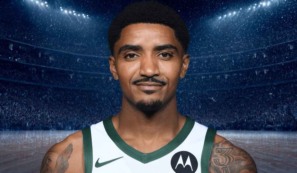 Basketball player wearing a green and white jersey standing in an arena