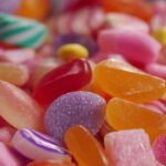 Close-up of assorted colorful gummy candies in shades of red, orange, pink, purple, and yellow