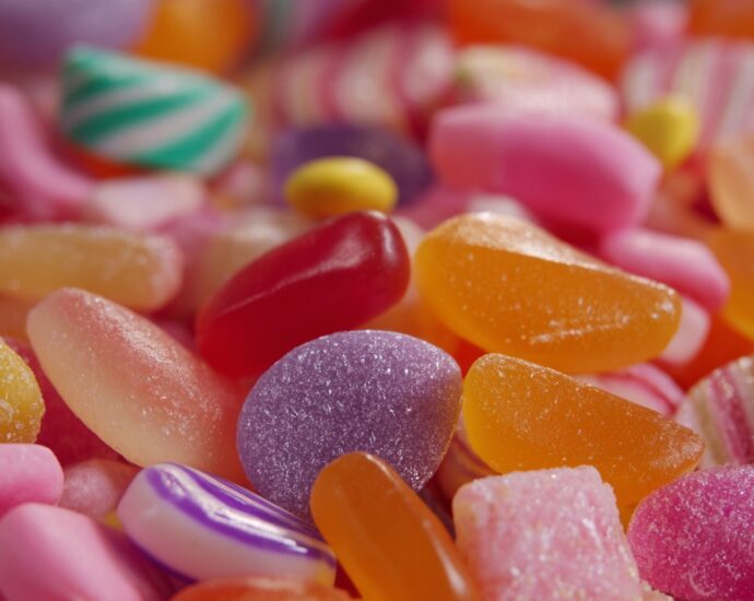 Close-up of assorted colorful gummy candies in shades of red, orange, pink, purple, and yellow