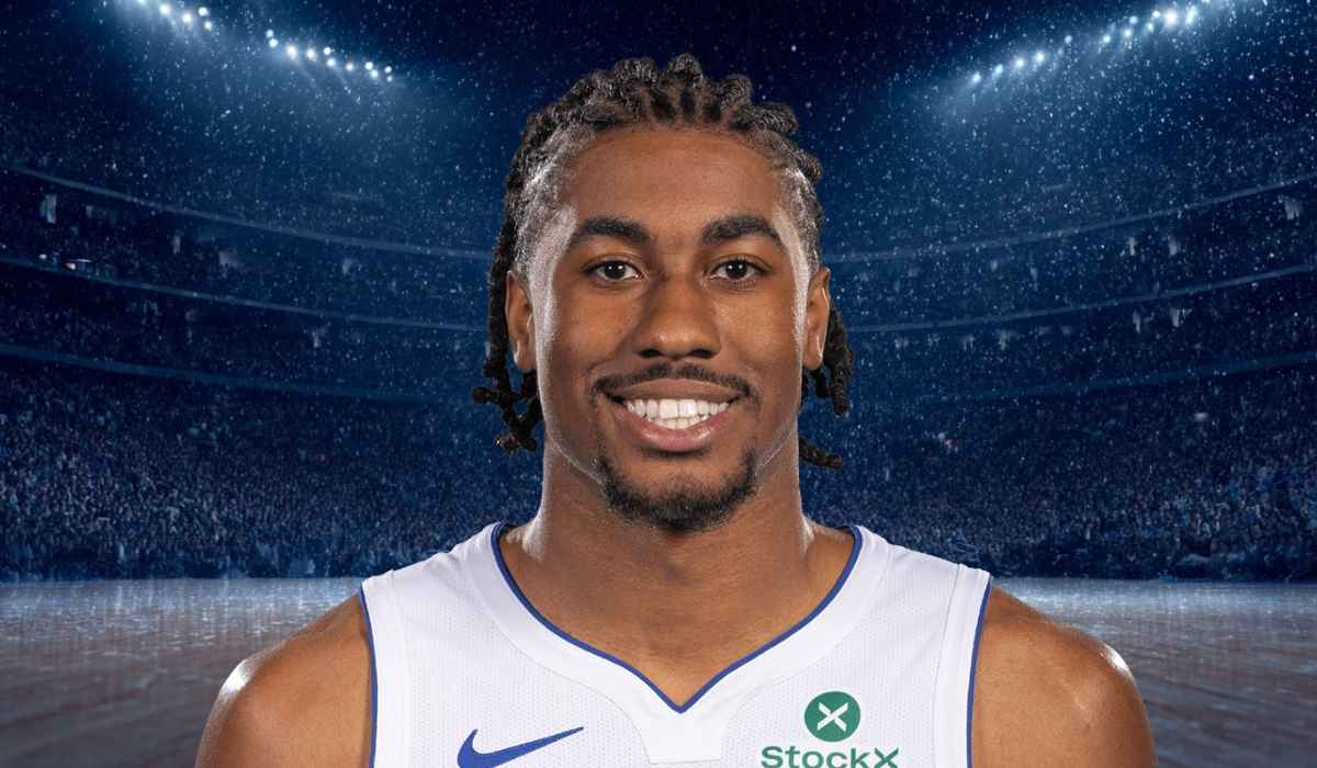 Basketball player smiling confidently in a packed stadium
