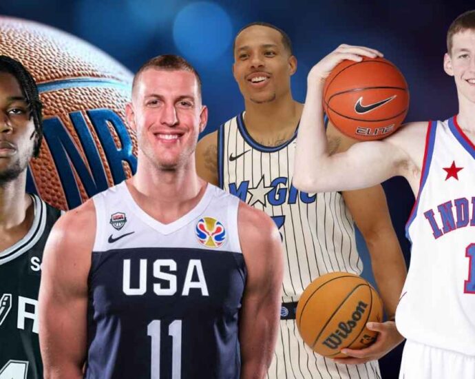 Group of basketball players wearing different jerseys standing in front of an NBA-themed background