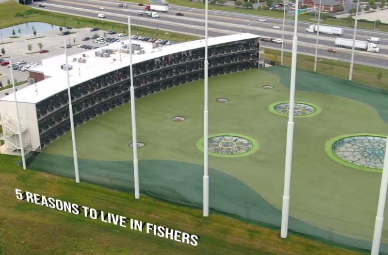 Aerial view of a large golf entertainment complex in Fishers near a major highway