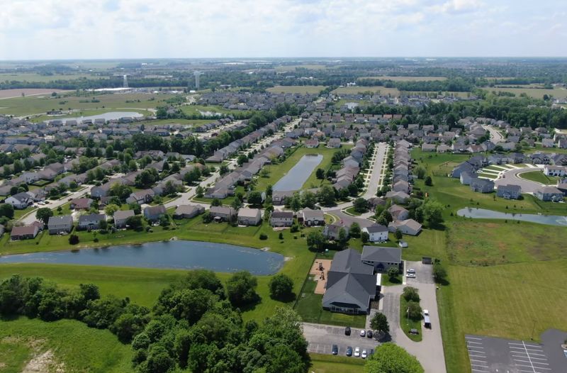 Aerial view of a McCordsville neighborhood with ponds, green space, and family homes