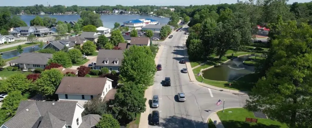 A quiet Indiana lake town with homes, trees, and local streets near the water