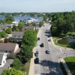A quiet Indiana lake town with homes, trees, and local streets near the water