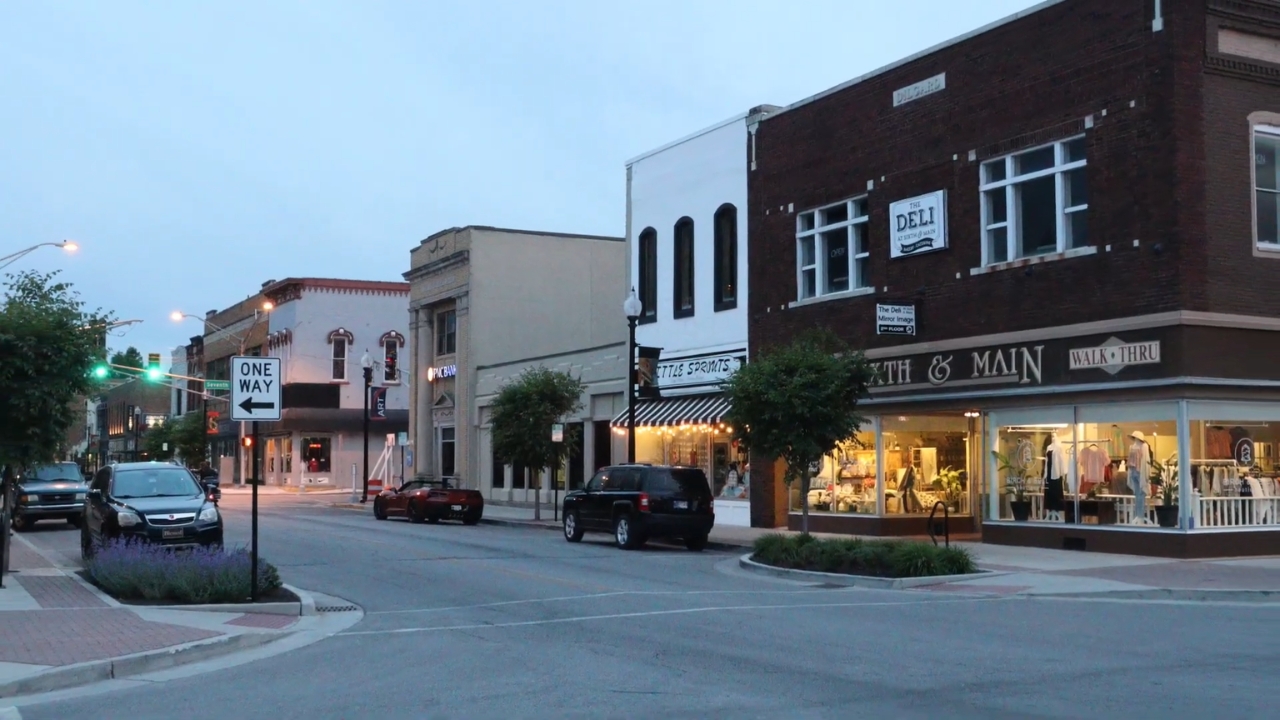 Downtown Auburn street with local shops and historic storefronts at dusk