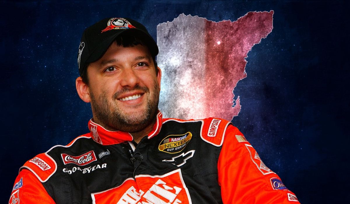 Race car driver in a racing suit and cap with a stylized background