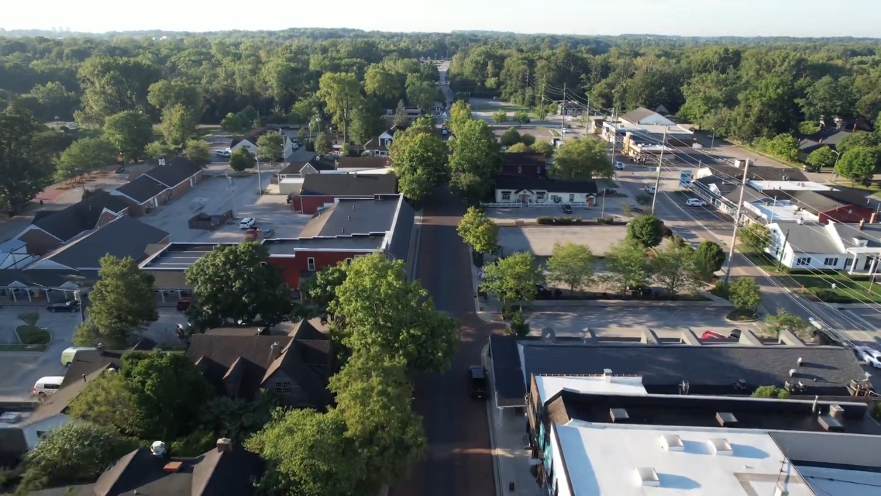 Aerial view of Zionsville with quiet streets, low buildings, and trees around town