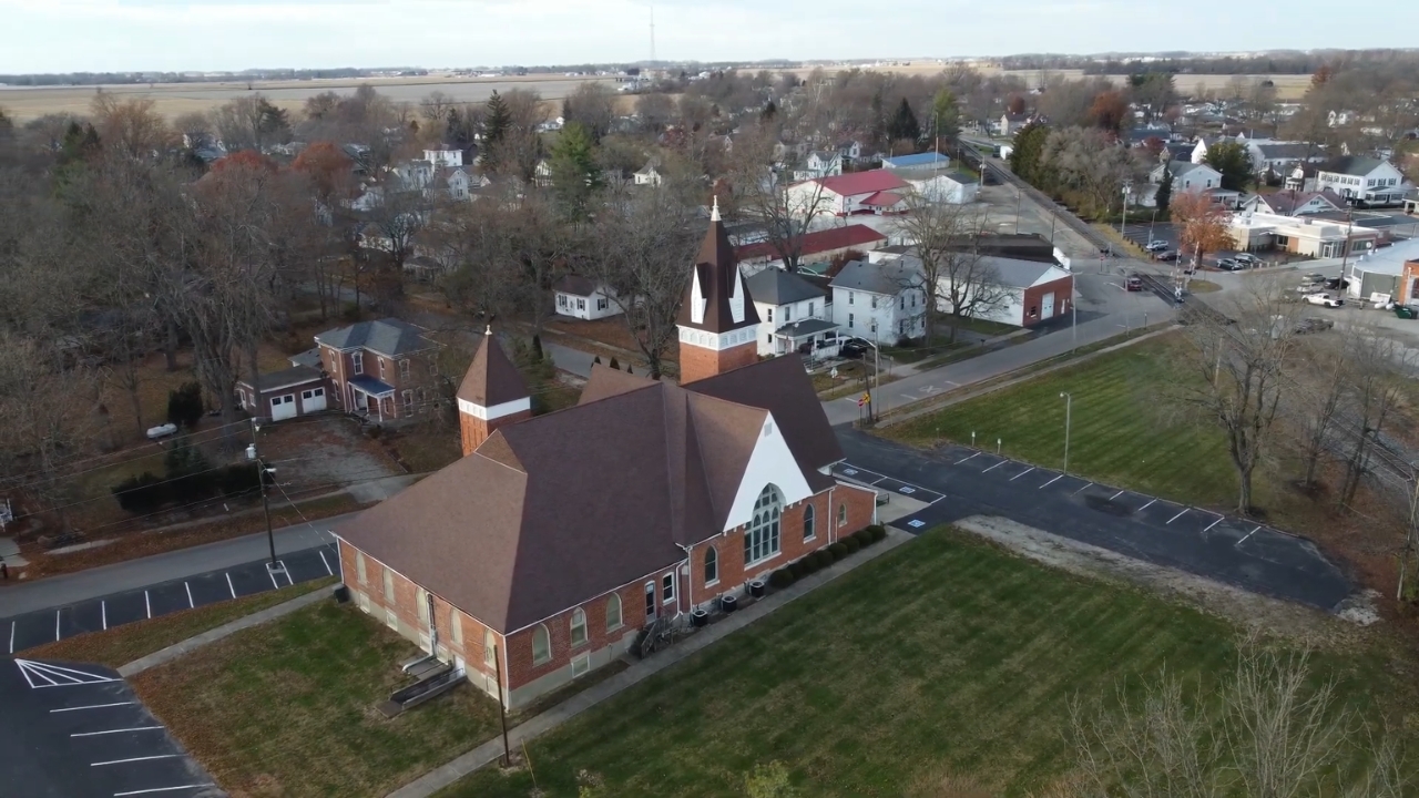 Aerial view of College Corner with a church, streets, and homes near the Indiana-Ohio line