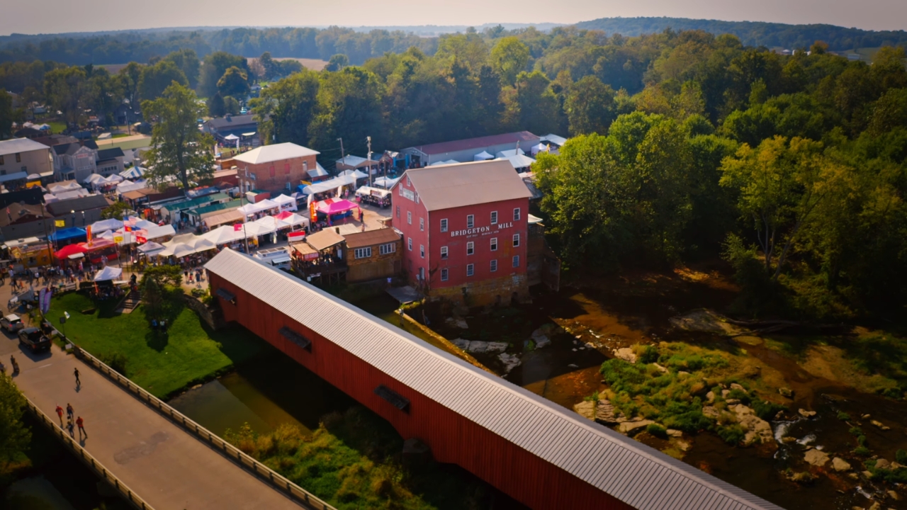 Aerial view of Bridgeton Covered Bridge, Bridgeton Mill, and nearby festival vendor tents