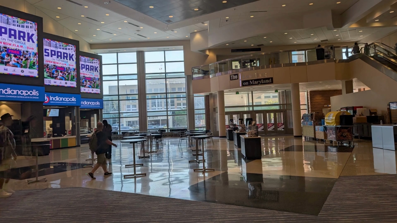 The Indiana Convention Center lobby has tables and a few visitors near the Maryland Street entrance