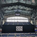 Gen Con banners and tabletop booths inside Lucas Oil Stadium in Indianapolis