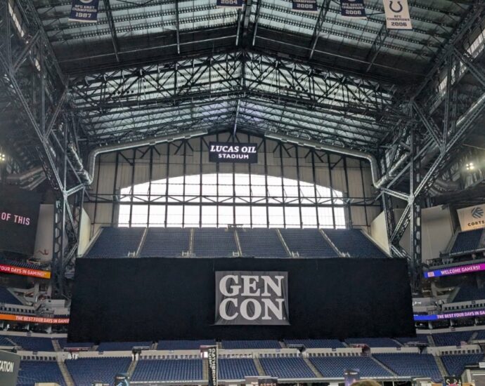 Gen Con banners and tabletop booths inside Lucas Oil Stadium in Indianapolis