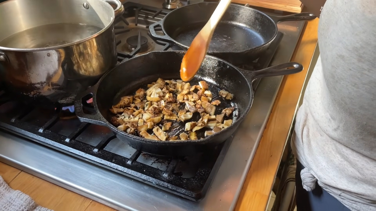 Chopped morel mushrooms cooking in a cast-iron skillet