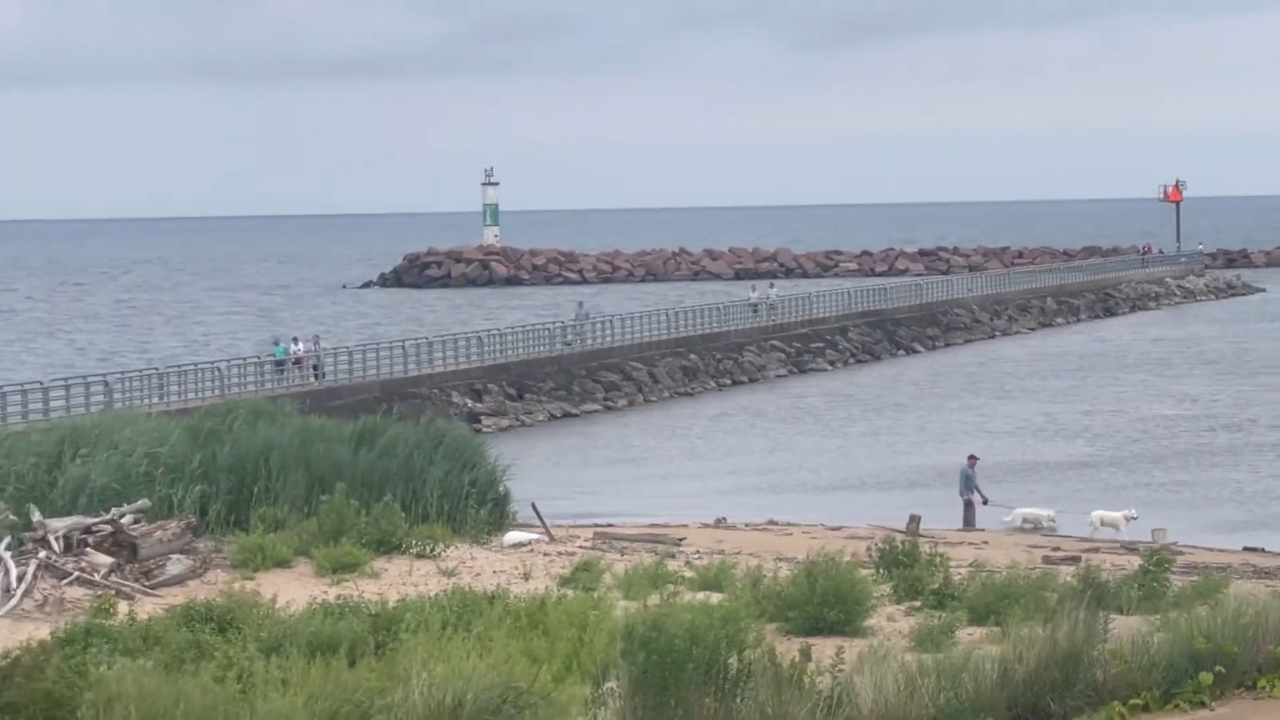 Visitors walk along the breakwater at Portage Lakefront and Riverwalk on Lake Michigan