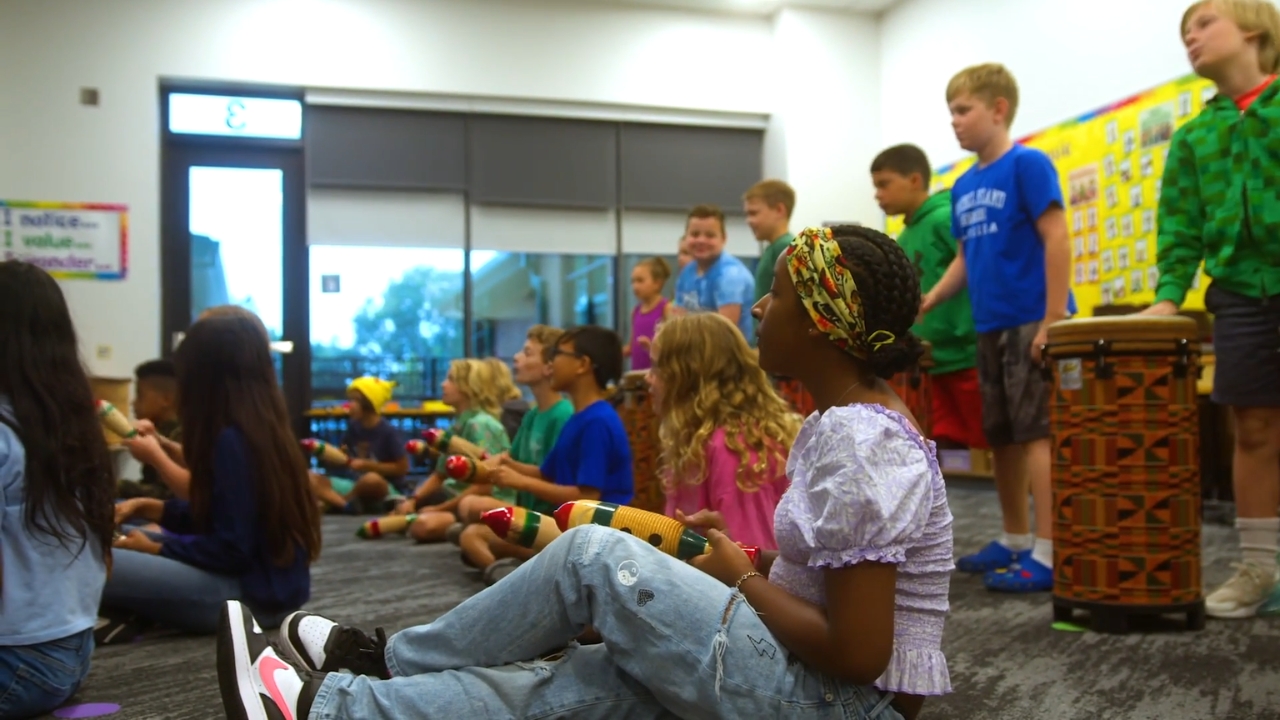 Children take part in a music activity inside a Carmel classroom