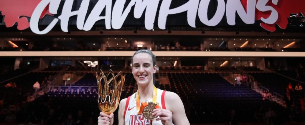 Caitlin Clark holds the championship trophy and medal after the final.