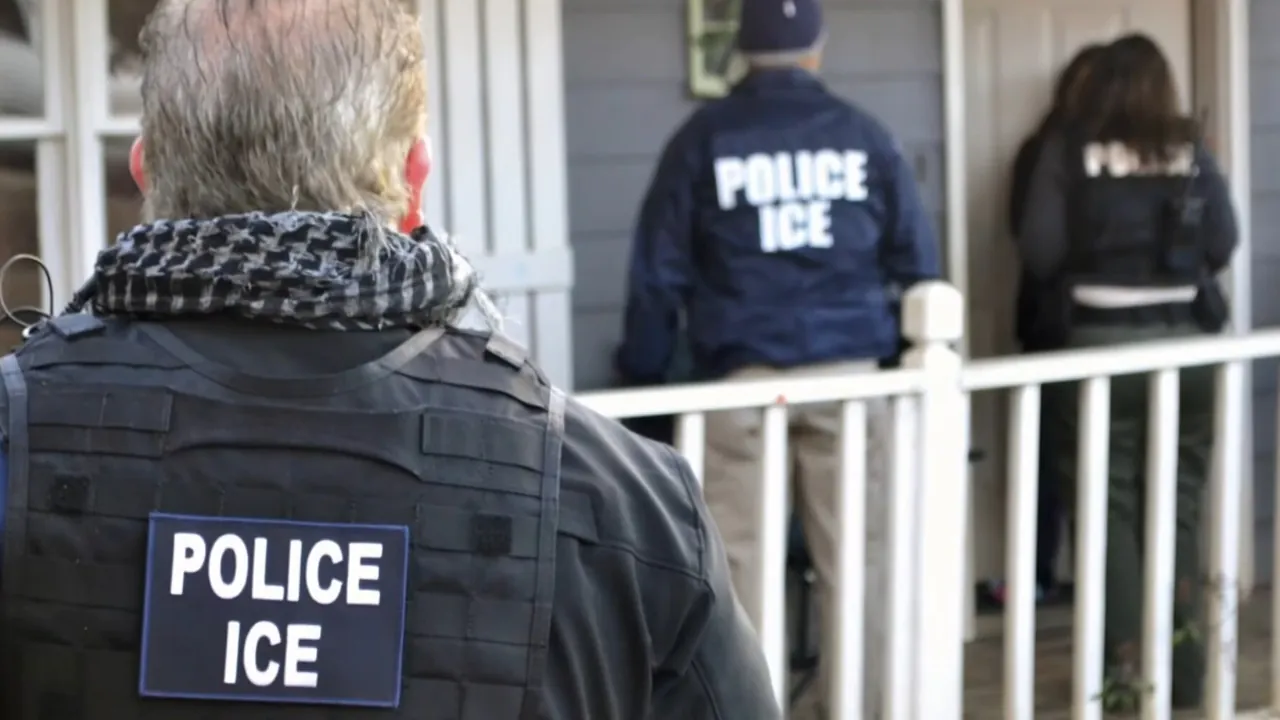 ICE officers stand outside a home as part of an enforcement operation.