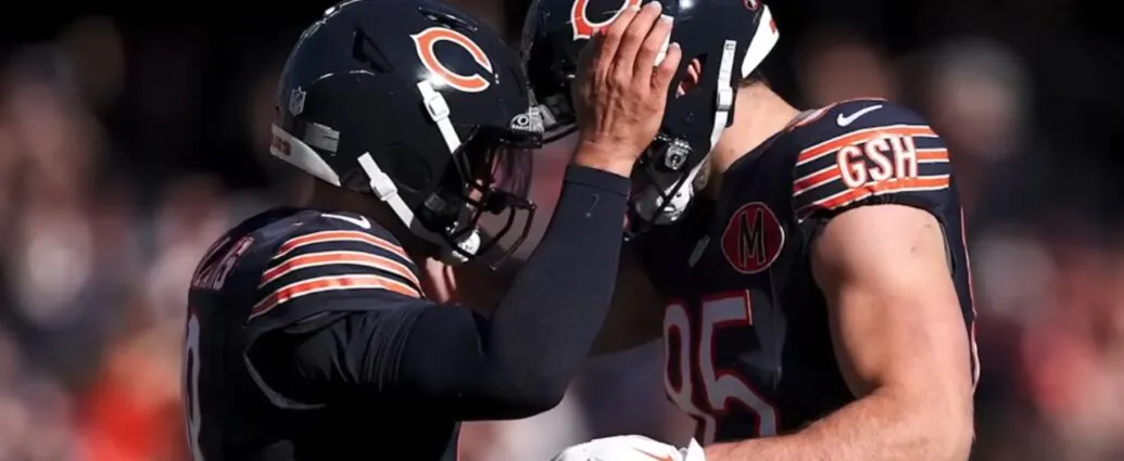 Two Chicago Bears players stand close together on the field.